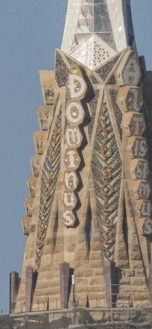 Closeup of the part of the tower just under the cross.  Arranged
in a row down this part of the spire is a series of seven gigantic flat stones,
each with a single white letter, spelling DOMINUS.