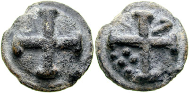 Pictures of the two sides of an
ancient, corroded, worn, weathered coin.  Each one has a four-armed
cross who arms have crossbars at the ends, and the one on the right
also has five dots.  The dots are in a cluster in the space between
the cross's lower and left arms, and are arranged in a row of three
and, closer to the center, a row of two.