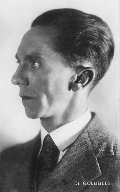 Actual archival photograph of Goebbels, in right profile, just
like Mickey Mouse Goebbels in the previous picture, but from the chest
up.  His mouth is
closed and he is wearing a wool suit, white shirt with collar, and a
wide necktie.