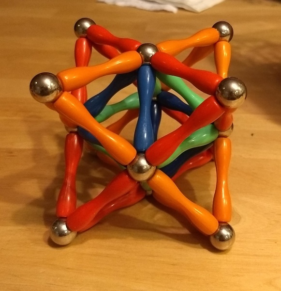 The octahedron from before, but withred tripods attached to its other four faces, making eight tripods in
all.  The final result looks like interpenetrating red and orange
tetrahedra, with the original octahedron in their intersection