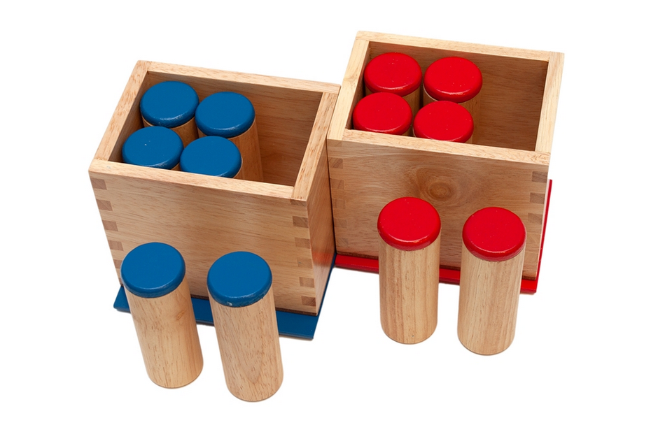 Two wooden boxes, each
containing a set of six wooden cylinders.  One set has red caps on the
ends, the other has blue caps.