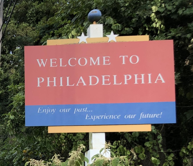 Red and blue roadside sign proclaiming WELCOME TO PHILADELPHIA