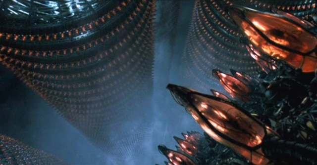 A still from the movie _The Matrix_
showing endless ranked columns of translucent pods, each containing an
inert human body.