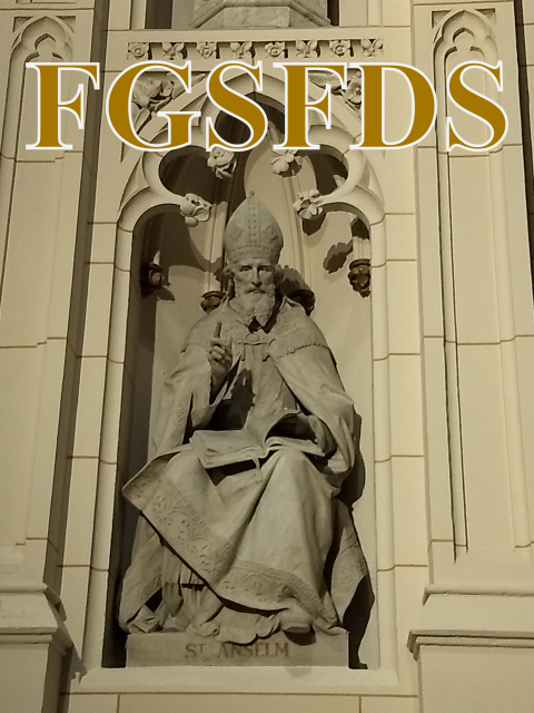 A stone sculpture of
Saint Anselm, who is bearded and wearing a mitre.  There is a book
open on his lap and his right-hand index finger is upraised.  The
caption FGSFDS is over his head in large letters.