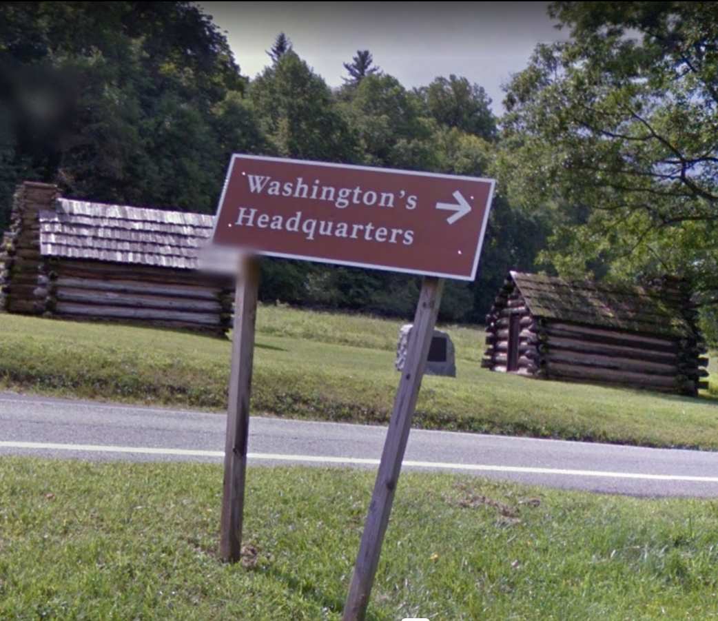 Photo of a brown guide sign at Valley Forge park with an arrow
and the words “Washington’s Headquarters”.