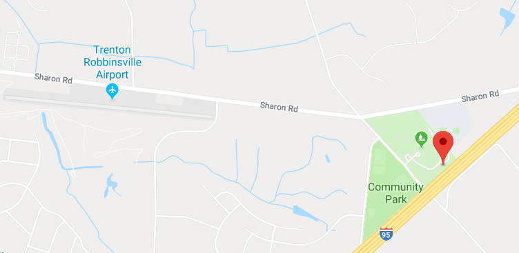 Screengrab of a Google map showing
the section of the Turnpike under discussion.  The turnpike runs from
southwest to northeast.  A red 'location' marker shows the point at
which the photograph was taken.  About half a mile east of the marker,
with its main runway pointing almost directly at the marker, is an
area labeled 'Trenton Robbinsville Airport'