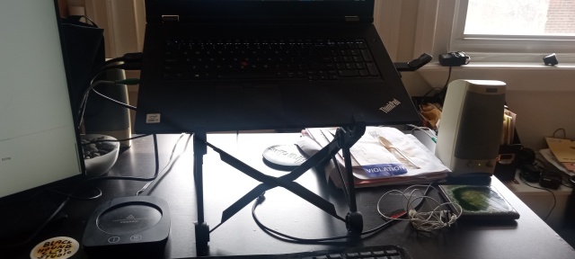 Laptop stand on my desk, supporting an unusually large laptop.